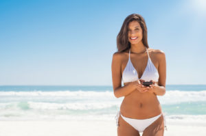 Young Woman in White Bikini on Beach