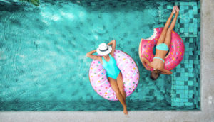 two women floating in pool