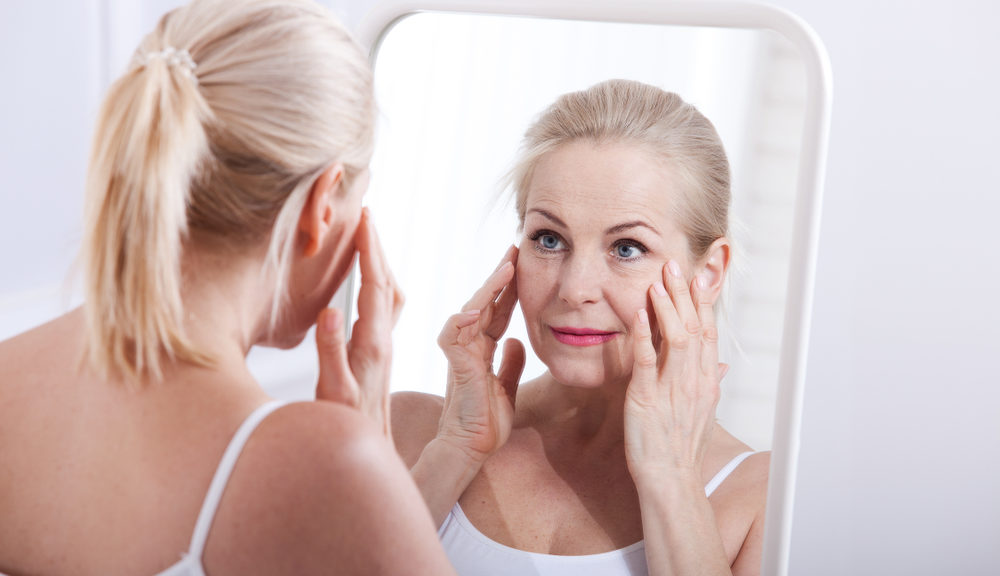 Woman Looking in Mirror at Wrinkles