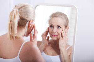 Woman Looking in Mirror at Wrinkles