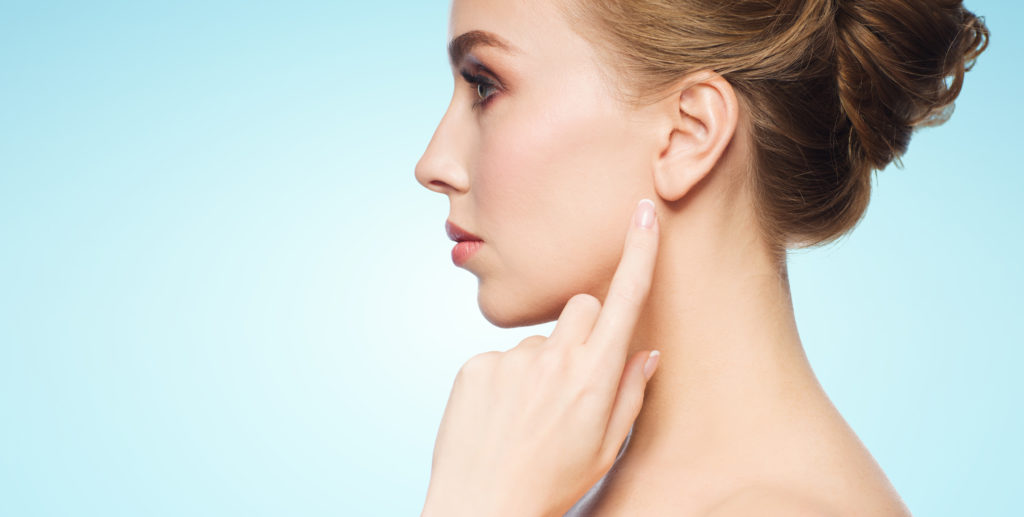 Profile View of Woman Pointing at Her Ear